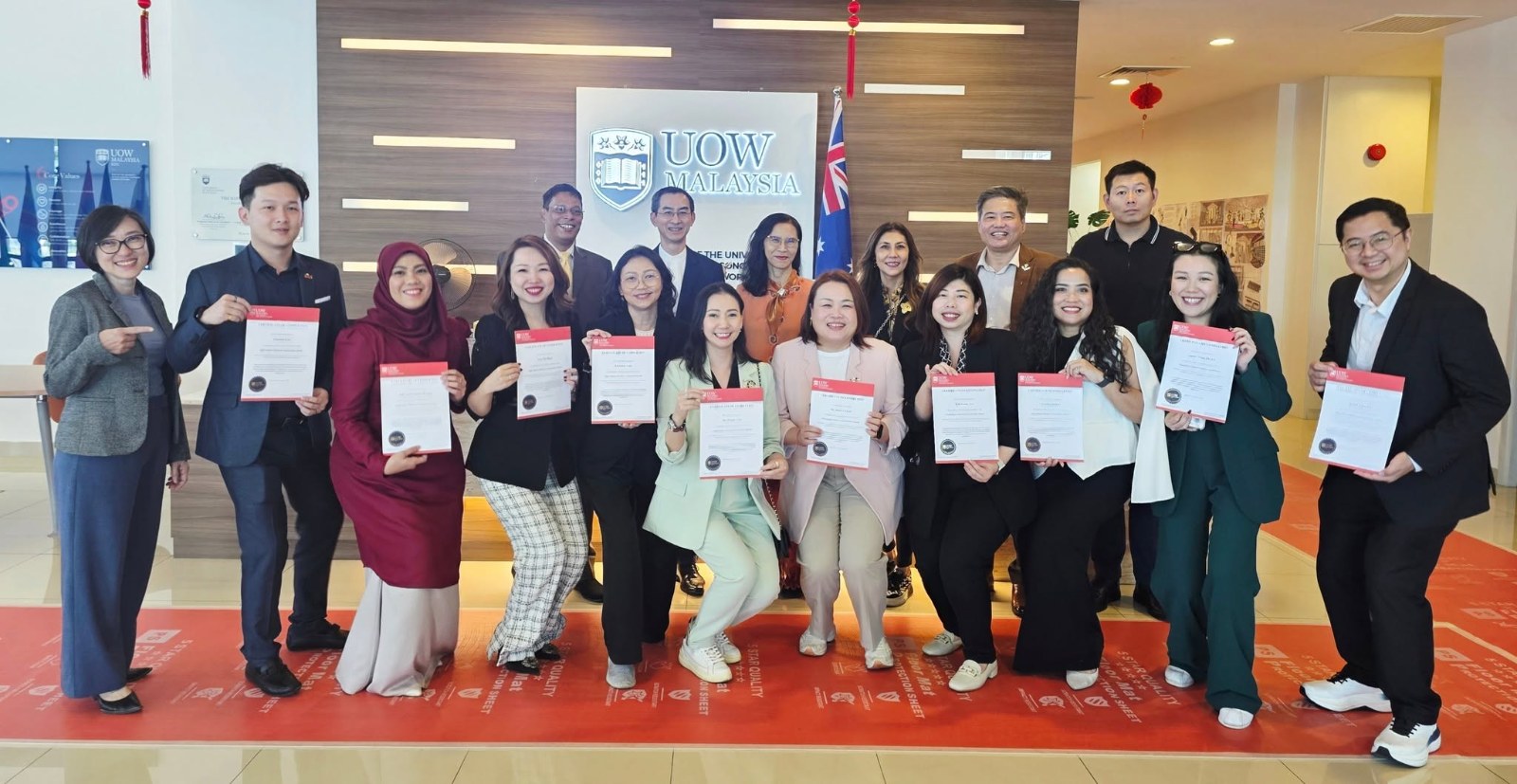 Participants receiving certificates at a professional development programme held at UOW Malaysia